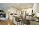 Modern kitchen with a granite countertop island, stainless steel appliances, and hardwood flooring at 1505 Sharnbrook Ct, Raleigh, NC 27614
