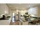 Bright kitchen with white cabinets, stainless steel appliances, and an island with seating at 1505 Sharnbrook Ct, Raleigh, NC 27614