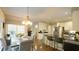 Eat-in kitchen featuring an island with barstool seating, stainless steel appliances, and an open dining area at 1505 Sharnbrook Ct, Raleigh, NC 27614