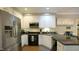 Contemporary kitchen with black appliances, sleek countertops, and white cabinets for a clean aesthetic at 1505 Sharnbrook Ct, Raleigh, NC 27614