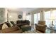 Spacious living room features hardwood floors, a cozy seating arrangement, and access to outdoor spaces at 1505 Sharnbrook Ct, Raleigh, NC 27614
