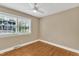 Sunny bedroom showcasing hardwood floors, neutral walls, and a large window at 154 Luther Rd, Raleigh, NC 27610