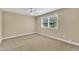 Neutral bedroom featuring carpet and a window at 154 Luther Rd, Raleigh, NC 27610