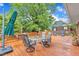 Large wooden deck with plenty of space for outdoor dining and relaxation, surrounded by lush greenery and trees at 154 Luther Rd, Raleigh, NC 27610