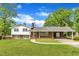 Charming two-story home with brick facade, lush lawn, and covered carport at 154 Luther Rd, Raleigh, NC 27610