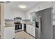 Bright kitchen with stainless steel appliances, white cabinetry, and granite countertops at 154 Luther Rd, Raleigh, NC 27610