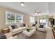 Bright living room with neutral colors, comfortable seating, and natural light from large windows and sliding glass doors at 154 Luther Rd, Raleigh, NC 27610