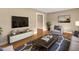 Cozy living room with hardwood floors, TV, comfortable seating, and natural light at 154 Luther Rd, Raleigh, NC 27610
