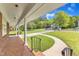 Welcoming front porch featuring brick accents and charming details, creating a warm and inviting entrance to the home at 154 Luther Rd, Raleigh, NC 27610