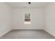 Carpeted bedroom with a ceiling fan and a window offering wooded views at 156 Southern Middle School Rd, Roxboro, NC 27573