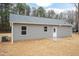 Back exterior view of home with gray siding and a small patio at 156 Southern Middle School Rd, Roxboro, NC 27573