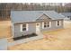 Charming gray home with a gray roof, white trim and yellow door, with a concrete walkway at 156 Southern Middle School Rd, Roxboro, NC 27573