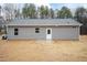 Back exterior view of home with gray siding and a small patio at 156 Southern Middle School Rd, Roxboro, NC 27573
