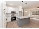 Well-lit kitchen featuring stainless appliances, granite countertops, and large island at 156 Southern Middle School Rd, Roxboro, NC 27573