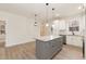 Spacious kitchen boasts gray island, white cabinets, granite countertops, and modern pendant lighting at 156 Southern Middle School Rd, Roxboro, NC 27573