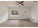 Open living area with a fan, window, and built-in storage and coat rack by the entry at 156 Southern Middle School Rd, Roxboro, NC 27573
