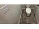 Neutral bathroom with toilet, gray tile floor, and light switch at 182 E Victory View Ter, Smithfield, NC 27577