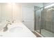 Bathroom features a double vanity, large mirror, and tiled shower with glass door at 182 E Victory View Ter, Smithfield, NC 27577