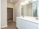 Bathroom featuring double vanity with white cabinets and a tiled shower at 182 E Victory View Ter, Smithfield, NC 27577