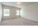 Spacious bedroom with neutral carpet, two windows, and ample natural light at 182 E Victory View Ter, Smithfield, NC 27577