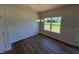 Dining room featuring wood floors, a window, and modern chandelier at 182 E Victory View Ter, Smithfield, NC 27577