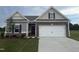 Charming single-Gathering home with stone accents, a two-car garage, and a well-manicured lawn at 182 E Victory View Ter, Smithfield, NC 27577