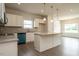 Well-lit kitchen with white cabinets, stainless steel appliances, and an island, creating a modern space at 182 E Victory View Ter, Smithfield, NC 27577