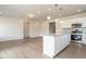 Open-concept kitchen with stainless appliances, granite counters, and island open to the living room at 182 E Victory View Ter, Smithfield, NC 27577