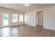 Bright living room with hardwood floors, large windows, and a door leading to the outdoor space at 182 E Victory View Ter, Smithfield, NC 27577