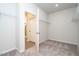 Carpeted walk-in closet with wire shelving and access to a bathroom at 182 E Victory View Ter, Smithfield, NC 27577