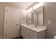 Bathroom featuring a double sink vanity with white countertops and modern fixtures at 213 Delma Grimes Rd, Coats, NC 27521