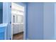 Hallway view of a full bathroom featuring a double sink vanity with white cabinets at 213 Delma Grimes Rd, Coats, NC 27521