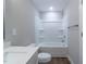 Bright bathroom featuring a single sink vanity, shower-tub, and tile floors at 213 Delma Grimes Rd, Coats, NC 27521