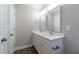 Bathroom featuring double sink vanity with white countertops and updated fixtures and hardware at 213 Delma Grimes Rd, Coats, NC 27521