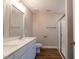 Bathroom featuring a double sink vanity and glass enclosed shower at 213 Delma Grimes Rd, Coats, NC 27521