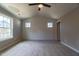 Bedroom with vaulted ceiling, ship lap accent wall, fan, and large windows for natural light at 213 Delma Grimes Rd, Coats, NC 27521