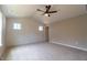 Bedroom with vaulted ceiling, ship lap accent wall, fan, and large windows for natural light at 213 Delma Grimes Rd, Coats, NC 27521