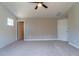 Bedroom with vaulted ceiling, fan, ship lap accent wall, carpet and neutral colored walls at 213 Delma Grimes Rd, Coats, NC 27521