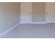 Carpeted bedroom with neutral colored walls and two white doors for closet and room access at 213 Delma Grimes Rd, Coats, NC 27521