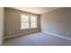 Bright bedroom with carpet, double windows, and neutral walls, offering a calm atmosphere at 213 Delma Grimes Rd, Coats, NC 27521