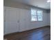 Inviting entryway with hardwood floors, wainscoting, a white door, and a window offering natural light at 213 Delma Grimes Rd, Coats, NC 27521