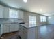 Charming kitchen with white cabinets, granite countertops, and stainless steel appliances at 213 Delma Grimes Rd, Coats, NC 27521
