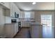 Modern kitchen featuring white cabinets, granite countertops, stainless steel appliances, and an island for extra prep space at 213 Delma Grimes Rd, Coats, NC 27521