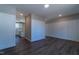 Open living space with hardwood floors, wainscoting wall trim, and a glimpse into the adjacent kitchen area at 213 Delma Grimes Rd, Coats, NC 27521
