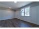 Bright living room featuring hardwood floors, wainscoting wall trim, and a large window letting in natural light at 213 Delma Grimes Rd, Coats, NC 27521