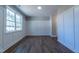 Bright living room featuring hardwood floors, wainscoting wall trim, and a large window letting in natural light at 213 Delma Grimes Rd, Coats, NC 27521