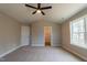 Vaulted ceiling primary bedroom offers natural light, neutral paint, and carpet at 213 Delma Grimes Rd, Coats, NC 27521