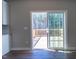 Bright room with a patio door leading to a wooden deck overlooking a wooded area at 213 Delma Grimes Rd, Coats, NC 27521