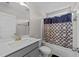 This bathroom has a vanity with a sink, mirror and lighting fixture, and a tub with a shower curtain at 220 Brisbane Dr, Zebulon, NC 27597