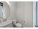 This bathroom features a pedestal sink and a toilet with a white seat and tank at 220 Brisbane Dr, Zebulon, NC 27597